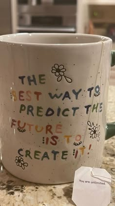 a coffee cup with the words, the best way to predict the future is to create it