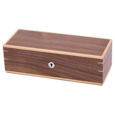 a wooden box with a metal button on the front and bottom, sitting on a white surface