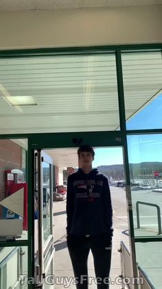 a man standing in front of a glass door