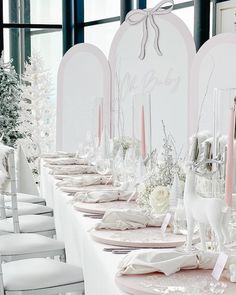 a long table set with pink and white decorations