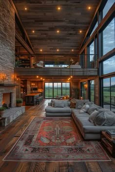 a large living room with lots of windows and couches in front of the fireplace