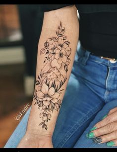 a woman's arm with flowers on it