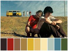 two people sitting on the ground in front of a yellow van and color swatches