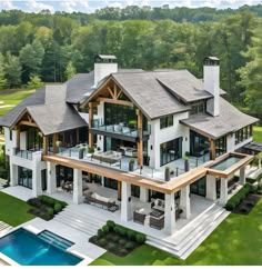 an aerial view of a large house in the woods