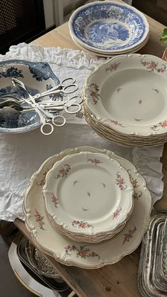 a table topped with lots of plates and silverware