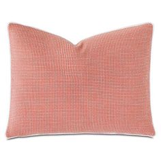 an orange and white pillow on a white background