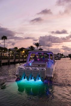 a white boat with blue lights in the water