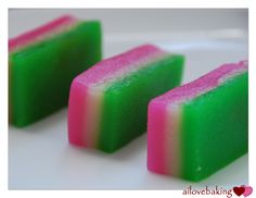 three different colored bars of soap on a white plate