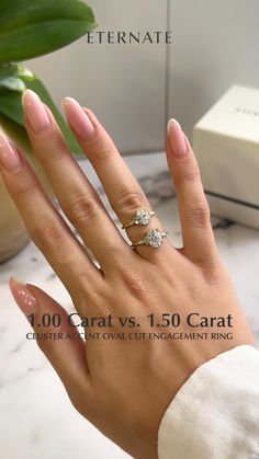 a woman's hand with two engagement rings on it and the words, 100 carats vs 1 50 carat