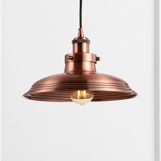 an antique copper pendant light hanging from the ceiling