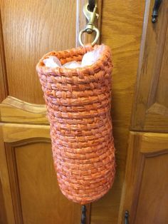 an orange basket hanging from a door handle