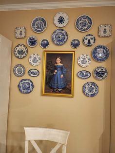 a painting on the wall with plates around it