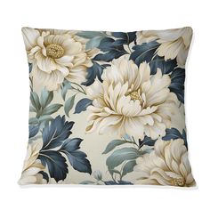 a white and blue pillow with large flowers on it