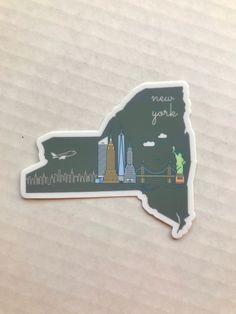 the new york sticker is shown on a piece of paper with an image of the city