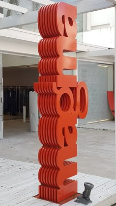 a large orange sign sitting on top of a wooden platform