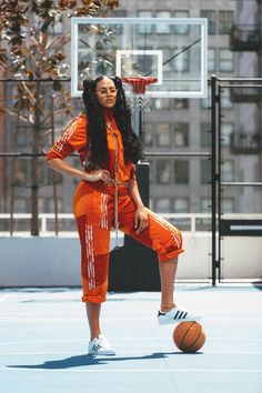 a woman in an orange jumpsuit playing basketball