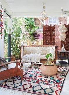 a living room filled with furniture and lots of plants