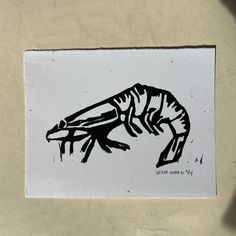 a piece of paper with a drawing of a lizard on it's back side