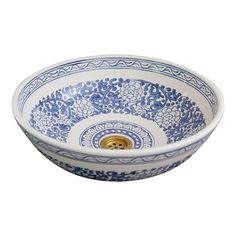 a blue and white bowl with an ornate design on the rim, in front of a white background