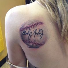 a woman with a baseball tattoo on her shoulder