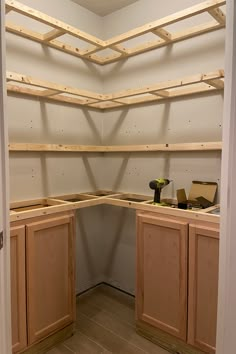 an unfinished kitchen with wooden cabinets and tools