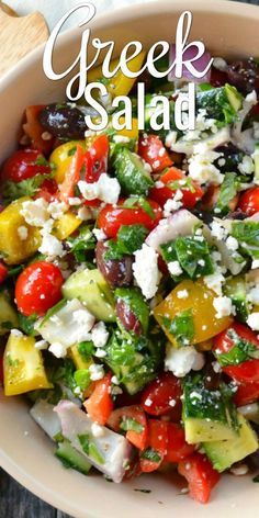 greek salad in a bowl with feta cheese and olives on top, ready to be eaten