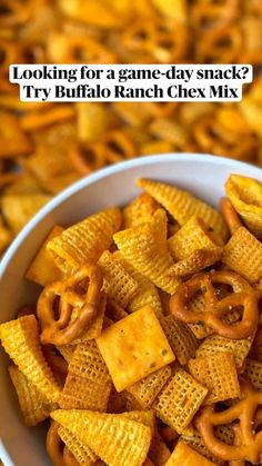 a white bowl filled with cheetos sitting on top of a pile of chips