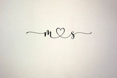 the word ms and s is written in cursive writing on a white wall