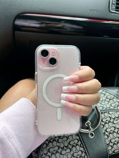 a woman holding up her phone case with the letter c on it