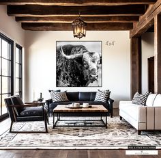 a living room filled with furniture and a cow painting on the wall