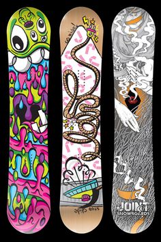 three snowboards with different designs on them