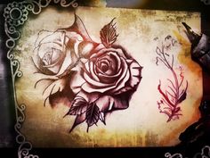 an artistic drawing of a rose and other flowers on a piece of paper with lace