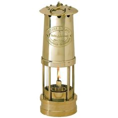 a small brass oil burner with a candle in the center on a white background