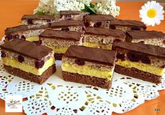 several pieces of cake on a doily with white flowers in the backgroud