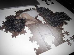 a person is laying on the floor with a puzzle piece in front of them that has been put together