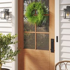 a wooden door with a green wreath on it