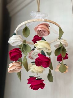 a mobile with flowers hanging from it's sides