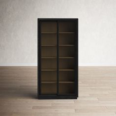 an empty bookcase sitting on top of a hard wood floor next to a white wall