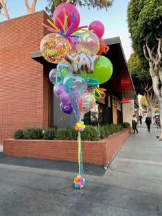 a bunch of balloons that are in the street