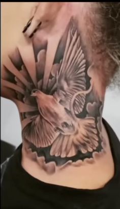 a woman with a bird tattoo on her neck and behind the neck is an eagle