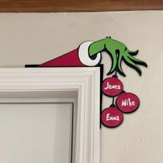 a sign on the wall that says, james mike buma and an elf's hat