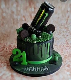 a birthday cake with an energy drink and cookies on top