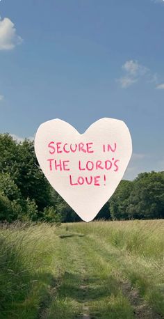 a heart shaped sign with the words secure in the lord's love written on it