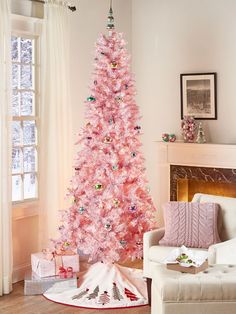 a pink christmas tree in a living room