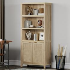 a wooden bookcase with wicker doors and drawers in a room next to a table