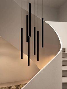 a staircase with several lights hanging from it