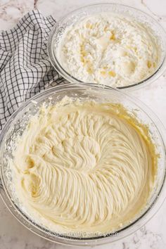 two glass bowls filled with batter on top of a marble countertop next to a black and white checkered towel