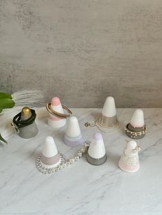 a table topped with lots of different types of jewelry