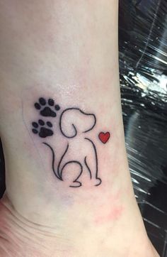 a small dog with a heart tattoo on the ankle