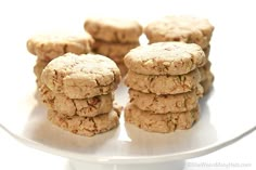 several cookies stacked on top of each other on a white plate with one cookie in the middle